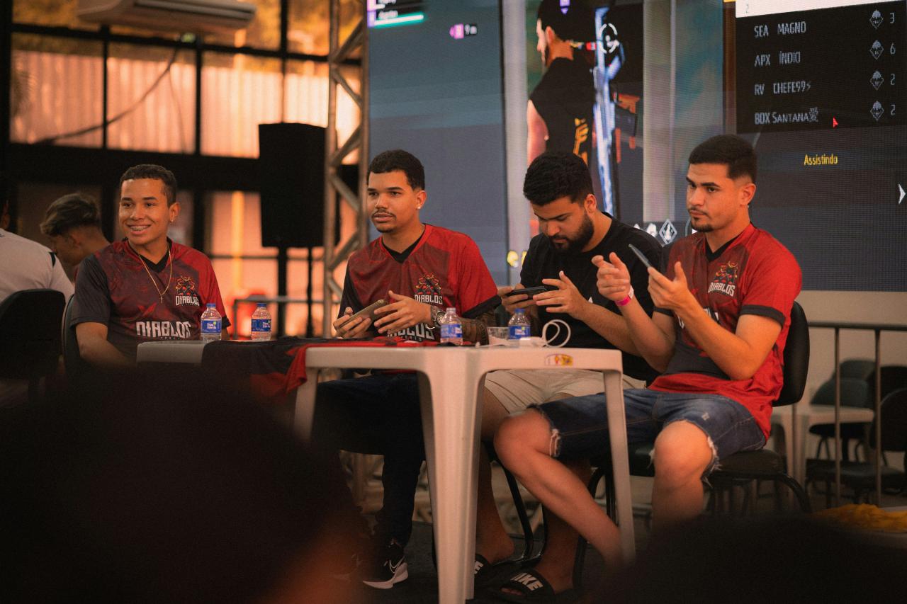 Four men sitting at a table during an event
